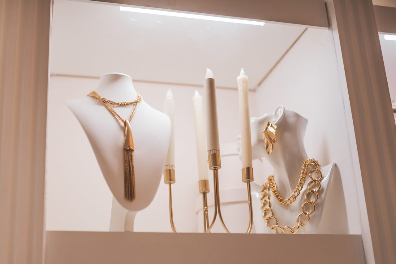 luxury gold jewelry on set holders and in jewelry box on light dressing table and wardrobe shelves 2.jpg